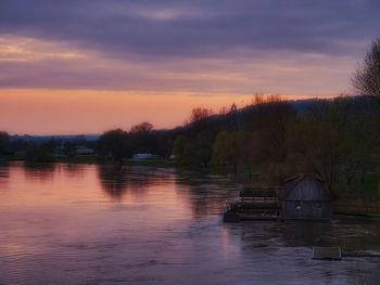 Scenic view of lake against sky during sunset
