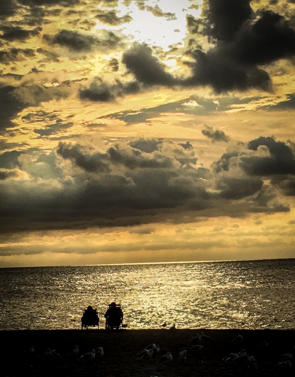 SILHOUETTE PEOPLE ON BEACH DURING SUNSET