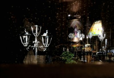 Close-up of glass of wine on table at night