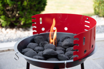 A man lights a fire with a lighter special charcoals for a barbecue