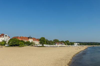 Scenic view of beach against clear blue sky