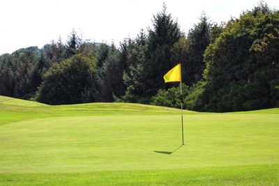 View of golf course against sky