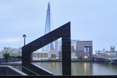 View of bridge over river against buildings in city