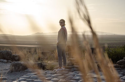 Man standing on land against sky