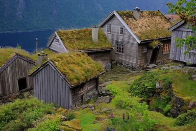 Old house by building against sky