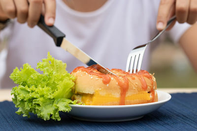 Close-up of person preparing food in plate