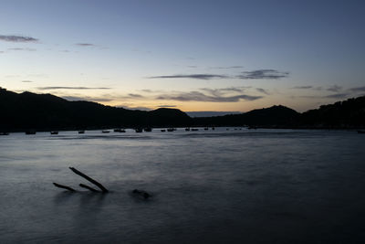 Scenic view of lake against sky at sunset