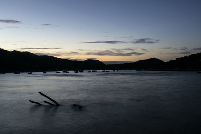 Scenic view of lake against sky at sunset