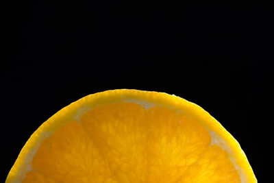 Close-up of lemon slice against black background