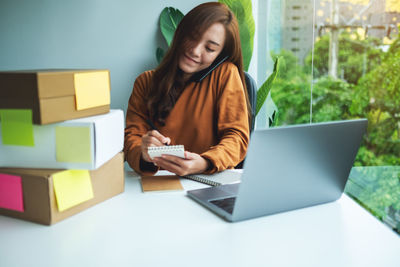 Portrait of woman using digital tablet on table