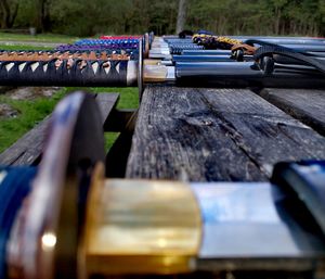 Close-up of katana swords on bench