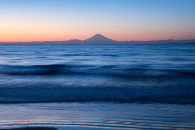 Scenic view of sea against clear sky during sunset