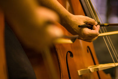 Cropped image of violinist playing violin indoors