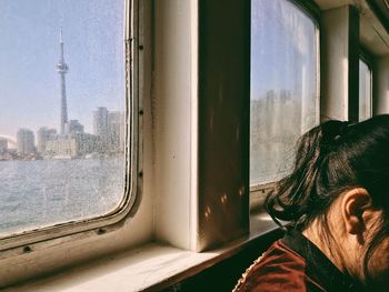 Portrait of man looking through window