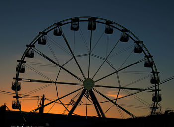 Low angle view of ferris wheel against sky