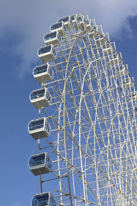 Low angle view of ferris wheel against blue sky