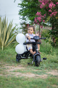 Side view of man riding push scooter on field