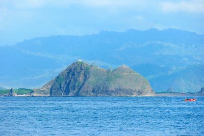 Scenic view of sea and mountains against sky