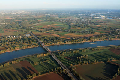 High angle view of river amidst cityscape against sky