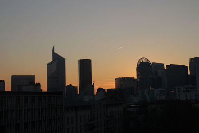 Cityscape against sky at dusk