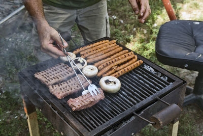 Preparing barbecue meat at picnic in nature. the meat is roasted in a conventional way.