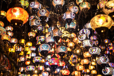Low angle view of illuminated lanterns in store for sale at market stall