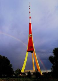 Low angle view of rainbow tower against cloudy sky
