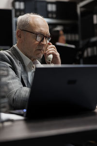 Young man using laptop at office