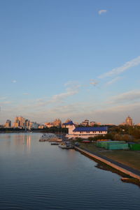 River by buildings against sky in city