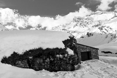 Scenic view of snow covered mountains against sky