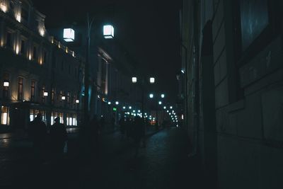 Illuminated street lights in city at night