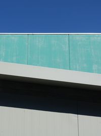 Close-up of built structure against blue sky