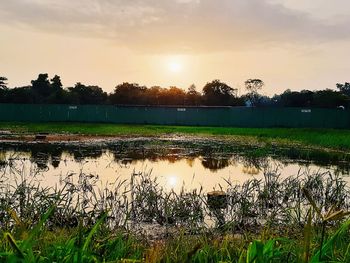 Scenic view of lake against sky during sunset