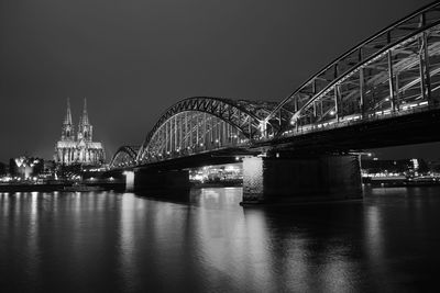 View of bridge over city at night
