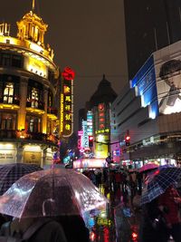 Illuminated city street and buildings at night