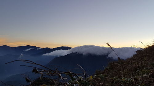 Scenic view of silhouette mountains against sky at sunset