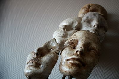 Close-up of a statue of faces