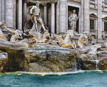 Statue of fountain in front of building