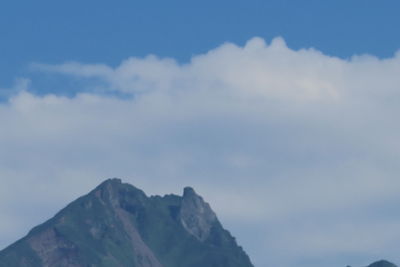 Low angle view of mountains against blue sky