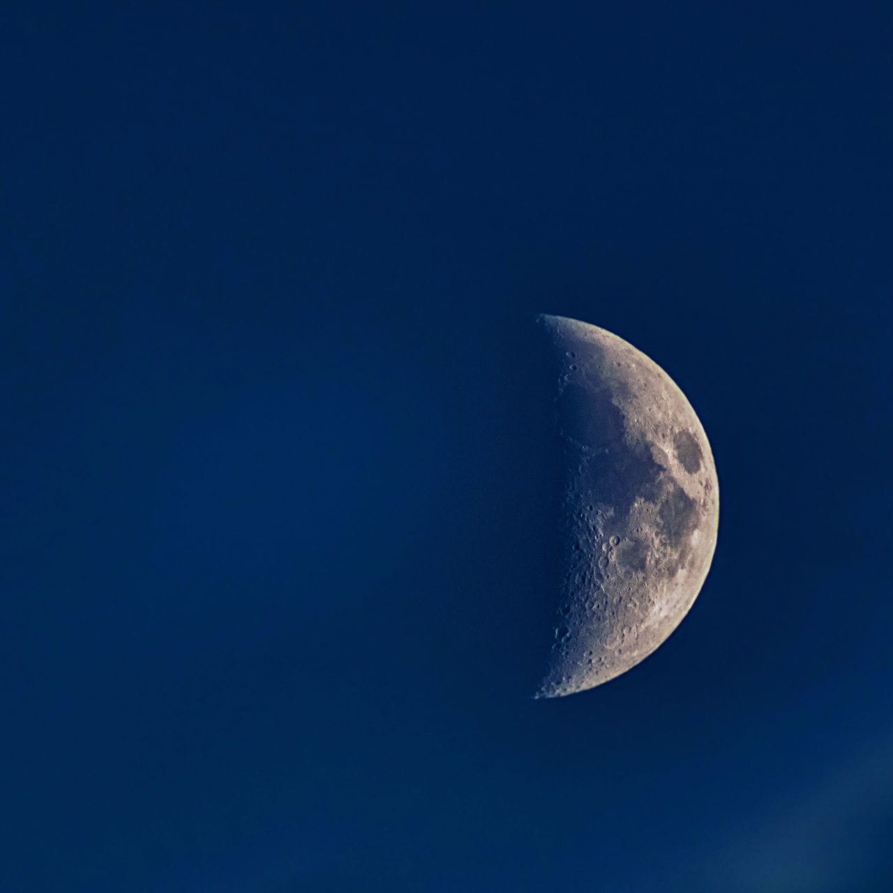 LOW ANGLE VIEW OF MOON AGAINST CLEAR BLUE SKY
