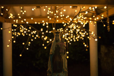 Close-up of illuminated lighting equipment hanging on ceiling