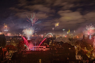 Firework display in city at night