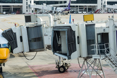 Shopping cart at airport against building in city