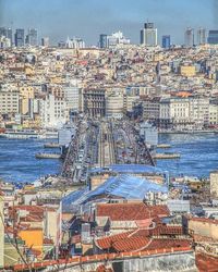 High angle view of buildings by sea against sky