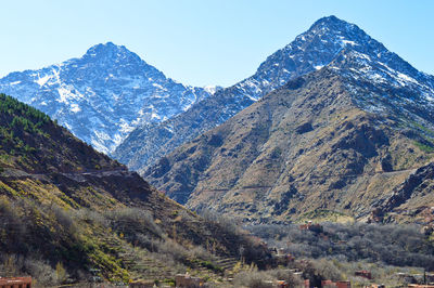 Scenic view of snowcapped mountains against clear sky