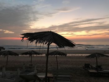 Lifeguard hut at beach against sky during sunset