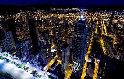 Aerial view of city lit up at night