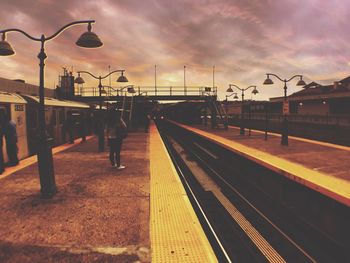 Railroad track against cloudy sky