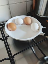 High angle view of eggs in container on stove