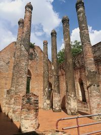 Low angle view of old ruin building against cloudy sky